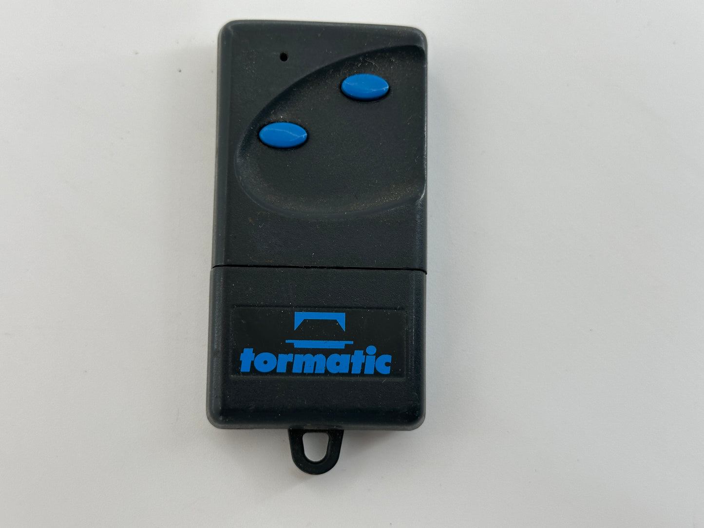 Tormatic. Hand transmitter, handle, remote control, radio button, radio remote control